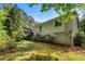 Home's exterior featuring a wooden deck and a well-maintained lawn at 1824 Mcclung Rd, Hiram, GA 30141