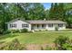 Well-maintained single-story home with a charming front porch and fresh landscaping, inviting curb appeal at 1824 Mcclung Rd, Hiram, GA 30141