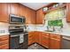 Kitchen featuring stainless appliances, granite counters, wood cabinets and a stainless steel sink at 1824 Mcclung Rd, Hiram, GA 30141