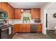 Kitchen with stainless appliances, wood cabinets, granite counters, and a stainless steel sink at 1824 Mcclung Rd, Hiram, GA 30141