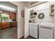 Well-organized laundry area with stainless steel appliances, storage, and tile floors at 1824 Mcclung Rd, Hiram, GA 30141