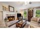 Inviting living room featuring a brick fireplace, neutral-toned furniture, and ample natural light at 1824 Mcclung Rd, Hiram, GA 30141