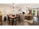 Open-concept living room and dining area featuring a fireplace, wood floors, and lots of natural light at 1824 Mcclung Rd, Hiram, GA 30141