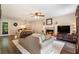 Cozy living room featuring a brick fireplace, comfortable seating, and modern flooring, perfect for relaxation at 1824 Mcclung Rd, Hiram, GA 30141