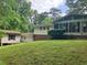 A lush backyard view with a detached building near the main house at 215 N Etowah Ct, Canton, GA 30114