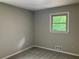 A charming bedroom with soft gray walls, a bright window and neutral carpet at 215 N Etowah Ct, Canton, GA 30114