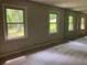 Neutral primary bedroom featuring large windows and mirrored closet at 215 N Etowah Ct, Canton, GA 30114