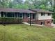 A two-story home boasts brick accents, siding, a well-kept lawn, and a charming front entrance at 215 N Etowah Ct, Canton, GA 30114