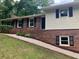 Close-up of the home's front, highlighting the brickwork, siding, and inviting entryway with manicured landscaping at 215 N Etowah Ct, Canton, GA 30114