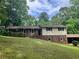 Charming two-story home with a brick and vinyl exterior, accented by black shutters and a well-manicured lawn at 215 N Etowah Ct, Canton, GA 30114