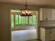 Bright kitchen featuring modern light fixture, neutral cabinets and floors with views to the sunroom at 215 N Etowah Ct, Canton, GA 30114