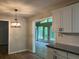 Open kitchen area with white cabinets and modern lighting fixture at 215 N Etowah Ct, Canton, GA 30114