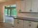Stylish kitchen featuring white cabinets, granite countertops, and a view to a sunroom at 215 N Etowah Ct, Canton, GA 30114