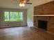 Spacious living room with a brick fireplace, large window, and neutral paint at 215 N Etowah Ct, Canton, GA 30114