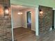 Open concept living area showcases brick detail and updated light fixtures at 215 N Etowah Ct, Canton, GA 30114