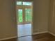 Neutral room featuring light walls and floors, with a view to the exterior through a glass door at 215 N Etowah Ct, Canton, GA 30114