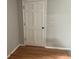 Neutral room showcasing hardwood floors and white door at 215 N Etowah Ct, Canton, GA 30114