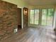 Spacious sunroom featuring brick wall and large windows overlooking private backyard at 215 N Etowah Ct, Canton, GA 30114