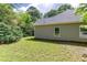 Wide shot of a home's backyard, featuring a tree line along the fence at 3314 Dilmus Dr, Powder Springs, GA 30127