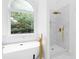 Bathroom featuring a modern tub next to a marble shower and large window overlooking the woods at 3314 Dilmus Dr, Powder Springs, GA 30127