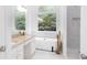 Bright bathroom with granite countertop, marble floors, and modern tub next to marble shower at 3314 Dilmus Dr, Powder Springs, GA 30127