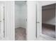 Hallway with doors leading to a closet and bedroom with marble floors and white trim at 3314 Dilmus Dr, Powder Springs, GA 30127