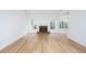 Bright living room with fireplace and large windows, showcasing the light wood flooring at 3314 Dilmus Dr, Powder Springs, GA 30127