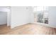Bright living room with light wood floors, fresh white walls, and a large window at 3314 Dilmus Dr, Powder Springs, GA 30127