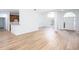 Light-filled living area featuring wood floors, white walls, and an open layout into the kitchen at 3314 Dilmus Dr, Powder Springs, GA 30127
