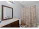 Cozy bathroom with vanity, toilet, and a shower curtain, offering functionality at 100 Fairview Dr, Stockbridge, GA 30281