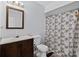 Cozy bathroom with vanity and tub-shower combination featuring a neutral-patterned shower curtain at 100 Fairview Dr, Stockbridge, GA 30281