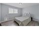 Neutral bedroom featuring a bed, shelving, wood-look floors, and a window at 100 Fairview Dr, Stockbridge, GA 30281