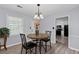 Bright dining area featuring a modern chandelier, stylish chairs, and a view into the modern kitchen at 100 Fairview Dr, Stockbridge, GA 30281