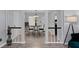 Inviting dining area with a chandelier, round table, and chairs, leading into a bright, open floor plan at 100 Fairview Dr, Stockbridge, GA 30281