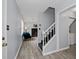 Welcoming entryway with a view of the staircase, fireplace, and easy access to the laundry room at 100 Fairview Dr, Stockbridge, GA 30281