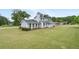 Well-maintained two-story home with a spacious lawn, mature trees, and classic architectural design at 100 Fairview Dr, Stockbridge, GA 30281