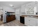Well-lit kitchen with white cabinets, a sink, and modern appliances, complemented by a unique fish tank at 100 Fairview Dr, Stockbridge, GA 30281