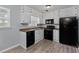 Modern kitchen with white cabinets and black appliances, offering functionality and style at 100 Fairview Dr, Stockbridge, GA 30281