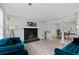 Living room featuring a decorative fireplace and opening to a dining area, perfect for entertaining guests at 100 Fairview Dr, Stockbridge, GA 30281