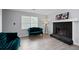 Cozy living room with a fireplace, teal sofas, a window, and modern decor, creating an inviting atmosphere at 100 Fairview Dr, Stockbridge, GA 30281