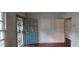 The living room has damaged walls, damaged flooring and an open door at 1182 Bronx Nw St, Atlanta, GA 30314
