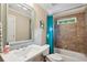 Well-lit bathroom features a vanity, toilet, and tiled shower/tub with modern fixtures and ample space at 2078 Marshalls Se Ln, Atlanta, GA 30316