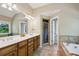 Bathroom with double sinks, a soaking tub, a tiled shower, and wood cabinetry at 2078 Marshalls Se Ln, Atlanta, GA 30316