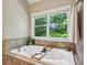 Large soaking tub with natural light from the garden window at 2078 Marshalls Se Ln, Atlanta, GA 30316