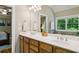 Bathroom with dual sinks, ample counter space, and natural light from the window at 2078 Marshalls Se Ln, Atlanta, GA 30316