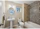 Bright bathroom with a pedestal sink, toilet, and tiled shower featuring a modern showerhead and fixture at 2078 Marshalls Se Ln, Atlanta, GA 30316