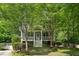 Attractive two-story home with a front porch, landscaped yard, and a concrete driveway leading to the property at 2078 Marshalls Se Ln, Atlanta, GA 30316