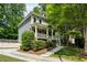 Charming two-story home with a covered front porch, landscaped yard, and a concrete driveway at 2078 Marshalls Se Ln, Atlanta, GA 30316
