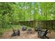 Charming backyard fire pit area with Adirondack chairs is perfect for entertaining guests at 2078 Marshalls Se Ln, Atlanta, GA 30316