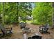 Secluded backyard fire pit surrounded by lush greenery provides a peaceful ambiance at 2078 Marshalls Se Ln, Atlanta, GA 30316